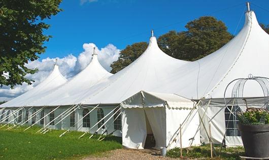 a row of blue portable restrooms waiting to be used at a special event in Rydal